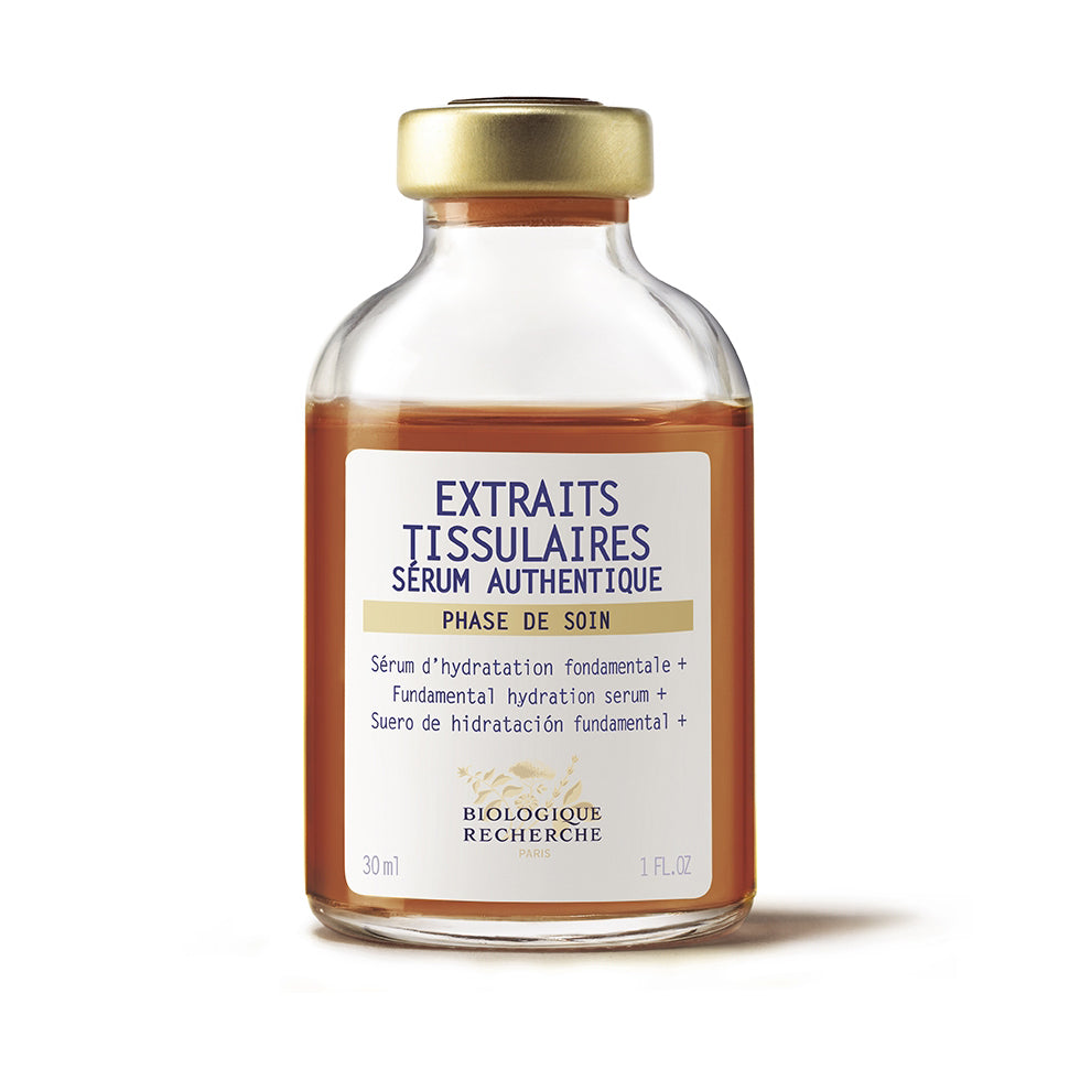 Biologique Recherche Serum Extraits Tissulaires – Glass serum bottle with gold cap containing brown liquid, featuring a white label with dark blue Biologique Recherche branding, shown on a white background. Size 1.0 fl.oz